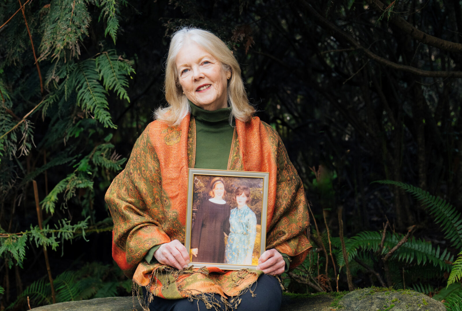 Woman holds frame photo of sister, an organ donor.